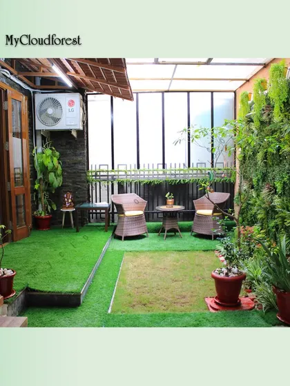 I converted this semi-enclosed patio into a cozy, all-weather retreat. By combining a full-length artificial green wall with soft turf and comfortable seating, I created a private mini-oasis perfect for relaxation in any season.