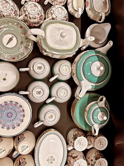 An overhead shot of a drawer filled with beautiful teacups and teapots. Organizing them this way ensures nothing gets broken and you can easily pick a set for tea time.