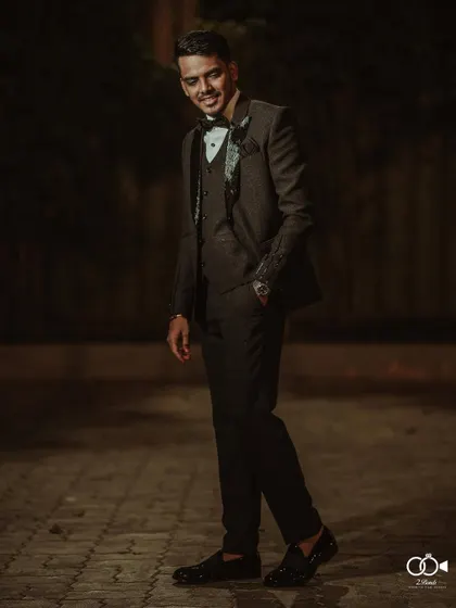 A duplicate of the dapper groom's portrait, a classic shot for any wedding album.