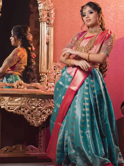 A different perspective of the teal and pink Langa Voni, showing the reflection in the mirror. The embroidered blouse adds so much richness to the outfit.
