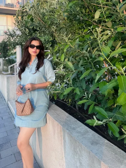 An outdoor shot of the Calvin Klein dress, capturing the golden hour light.