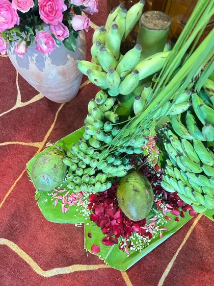 Traditional offerings like bananas and coconuts are beautifully arranged on banana leaves, seamlessly blending cultural rituals with high-end decor.