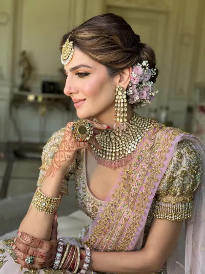 A bridal look is more than just a hairstyle; it's a crown. This soft, textured messy bun, adorned with fresh flowers, is a favorite I teach. It shows how to create volume and romance while ensuring the style is secure and comfortable for a long wedding day.