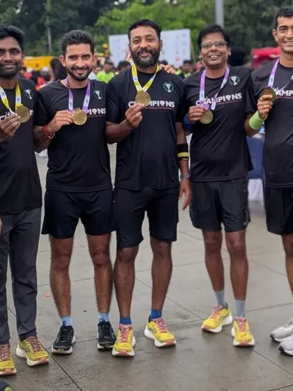 A proud moment for these runners, displaying the medals they earned through months of disciplined training and smart racing.