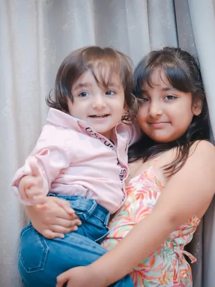A duplicate of image 23, showing a happy sibling moment.