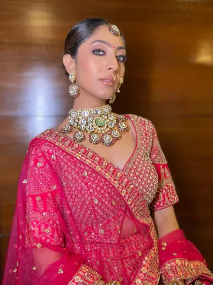 A powerful and modern bridal pose. The smokey kohl-rimmed eyes and contoured cheeks create a look that is both fierce and beautiful.