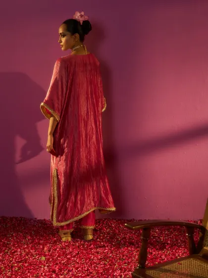 The back view of the crushed-fabric kaftan from the Kashidaa editorial. This shot was intentionally composed to highlight the garment's texture and drape, emphasizing the quiet luxury and craftsmanship of the piece.