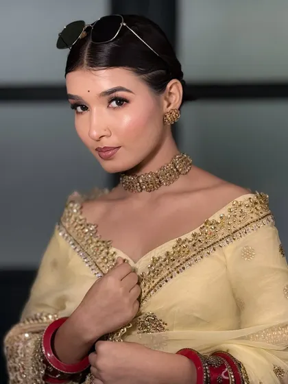 A modern and chic look with sunglasses perched on her head. This shows how versatile a soft glam makeup look can be.