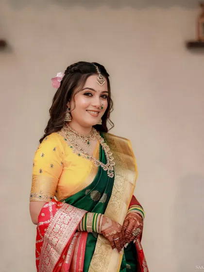 A close-up of the bride's happy face, with a pink flower in her hair adding a soft touch.