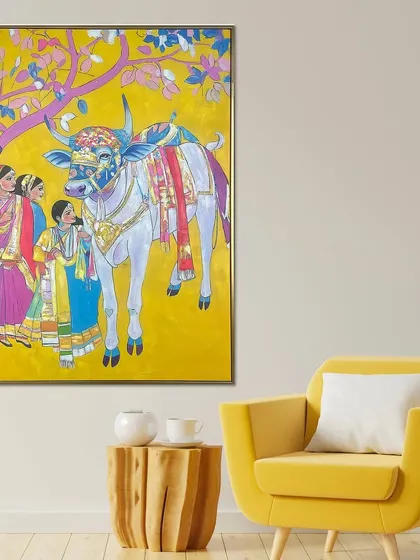 This hand-painted wall art shows the sacred cow, revered in Indian culture. The bright yellow background and traditional clothing of the figures give it a classic, folk-art feel.