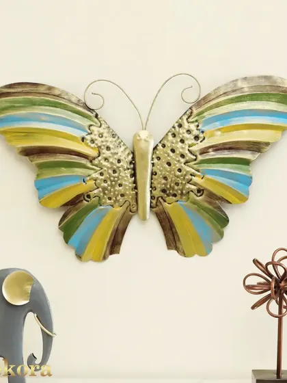 This colorful metal butterfly sculpture features striped wings in shades of blue, green, and yellow, bringing a cheerful and vibrant touch to any room.