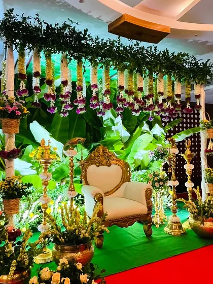 This is my signature South Indian Seemantham setup. I use fresh banana leaves for that lush green backdrop, complemented by hanging garlands of jasmine and tuberose, and traditional brass lamps to create a sacred, festive glow for your baby shower.