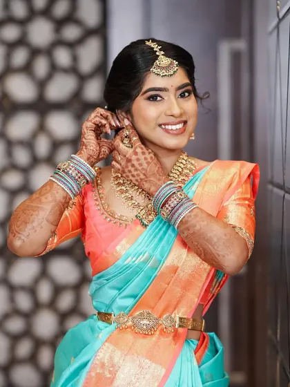 A happy and smiling Krithika. Her makeup is designed to enhance her natural beauty and make her feel confident.