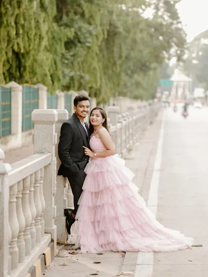 A romantic pose from the same Mysore pre-wedding shoot. The long trail of the pink gown creates a beautiful silhouette against the urban backdrop.