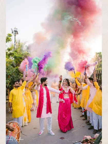 A wide shot of the couple's grand entrance with colorful smoke, creating a spectacular visual.