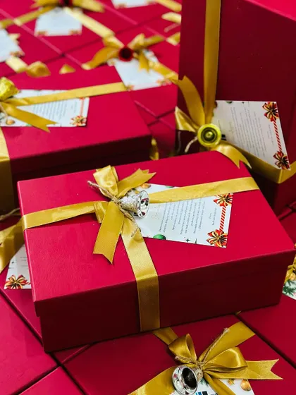 A close-up view of our beautifully wrapped red and gold gift boxes, perfect for corporate Christmas or New Year gifting.