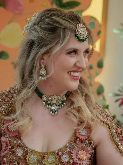 The beautiful bride, Alex, embracing Indian traditions with a smile as she participates in the Haldi ceremony.