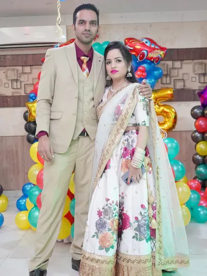 A couple in elegant formalwear poses at a birthday party. We capture the glamour and style of your event.
