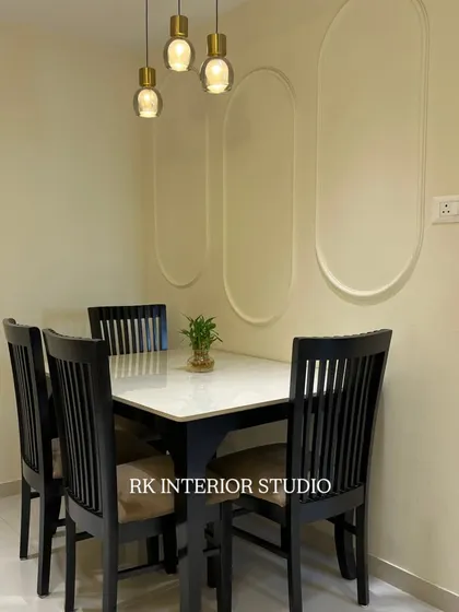 A simple yet elegant dining setup. I used wall mouldings and stylish pendant lights to define the dining nook and create a pleasant atmosphere for meals.