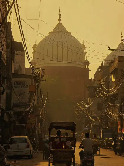 The golden hour light hitting the dome of the Jama Masjid, seen through the tangled wires of Old Delhi. This is the kind of organized chaos that makes the city so unique and photogenic.