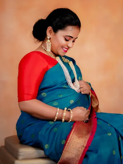 A sweet and happy moment captured during her maternity shoot. The makeup enhances her smile and the joyful glow of pregnancy.