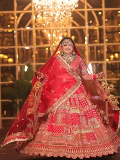Our beautiful bride Deepika in a vibrant red lehenga, looking like a princess on her wedding day.