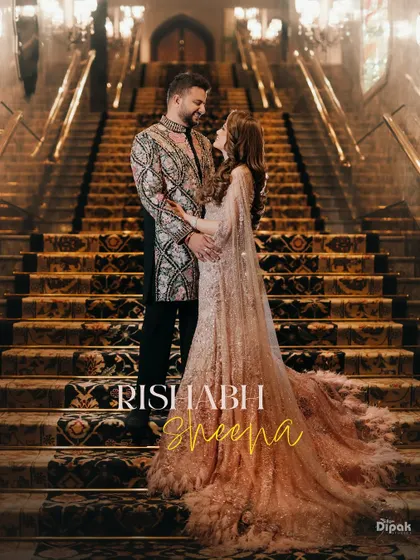 An engagement portrait on the grand staircase of a luxury hotel, capturing the couple in their exquisite traditional attire. This shot embodies the regal elegance and grandeur of a modern Indian love story.
