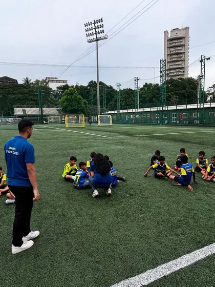 A wide shot of the sports psychology session on the turf.