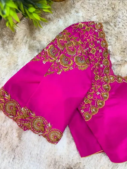 Another view of the heavily embroidered pink blouse, showing the richness of the zardosi and beadwork.