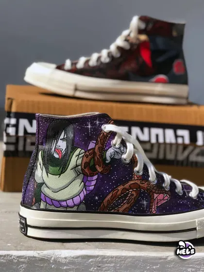A focused view of the Orochimaru custom Converse, with the Itachi shoe blurred in the background. This shot emphasizes the vibrant colors and details of the galaxy and snake design.