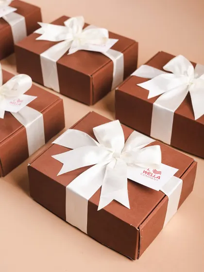 A collection of the finished Wella gift boxes, ready to be sent out. The clean, uniform look is perfect for professional corporate gifting.