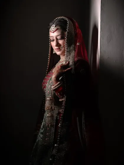 A moody and elegant bridal portrait, using shadows to create a dramatic and sophisticated look.