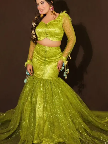 Another angle of the stunning lime green fish-cut lehenga, showing its beautiful trail. This is a modern and stylish outfit for any pre-wedding event.
