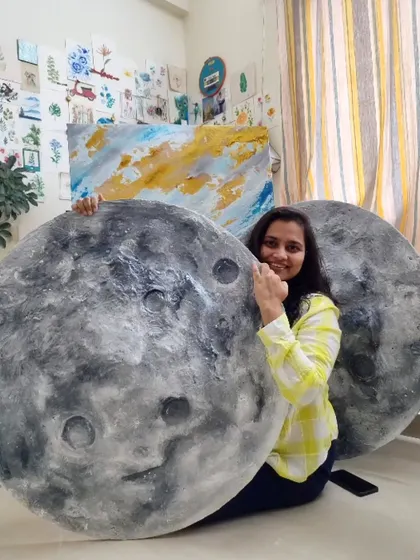 In the studio with a pair of custom moon murals before they head to their new home. Each one is handcrafted, ensuring no two pieces are exactly alike.