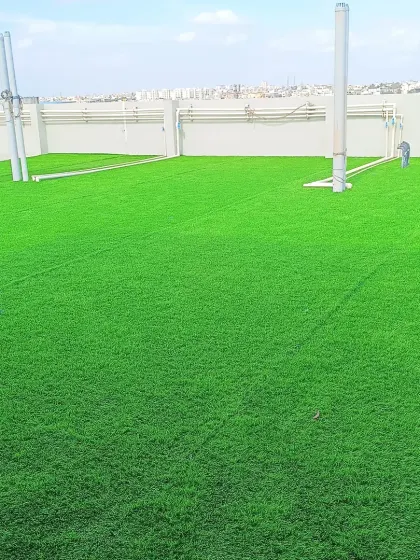 A close-up look at the lush, even surface of the installed artificial grass. It's a practical and aesthetically pleasing solution for urban outdoor living.