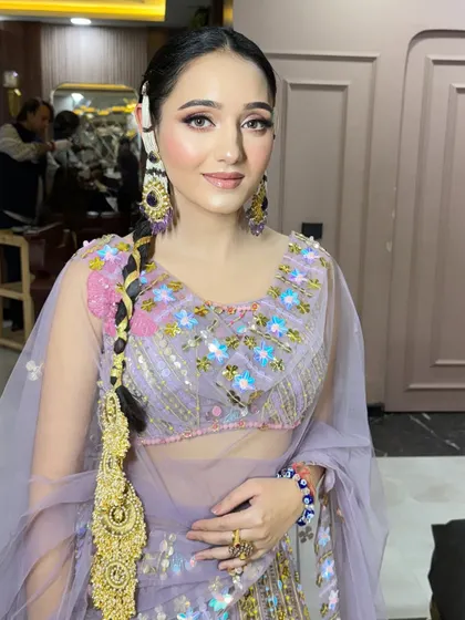 The traditional hairstyle and modern makeup create a beautiful fusion look.