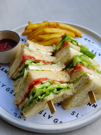 Classic club sandwiches, cut into quarters and served with a side of fries. A simple secret that tastes damn good.