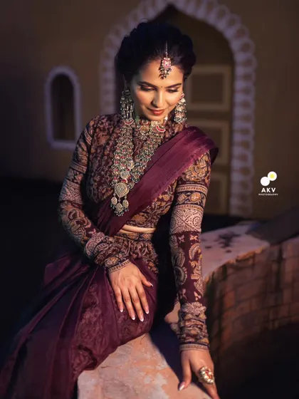 A serene and elegant portrait. The makeup is soft yet defined, with a focus on creating a flawless, glowing complexion that looks stunning in the warm, ambient light.