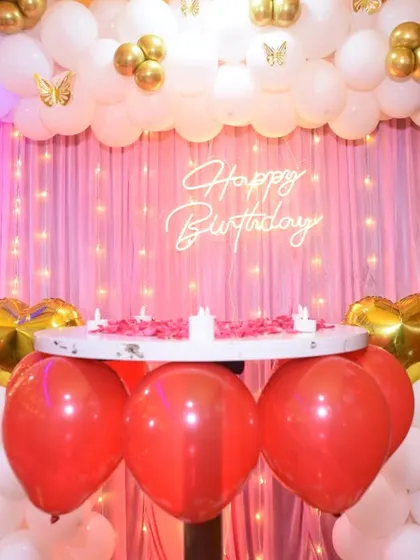 Another view of the red, white, and gold birthday decor, focusing on the cake table.