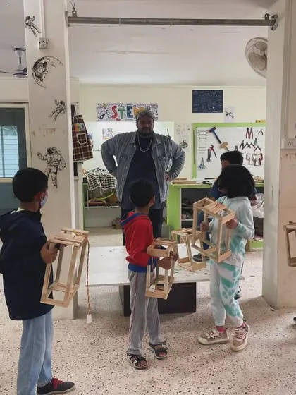 The instructor reviews the finished lanterns with the group. It's a great moment for the kids to see what they've accomplished as a team.