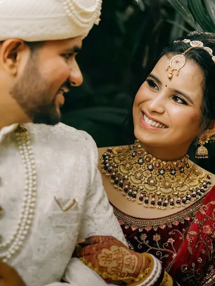 A beautiful candid moment where the bride looks at her groom with a loving smile. This close-up captures the genuine emotion and connection between the couple on their wedding day.