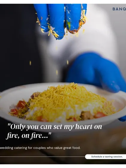 Our dishes are an orchestra of spices, flavours, and textures. Here, a chef adds the final sprinkle of sev to a plate of papdi chaat, creating a memorable experience one bite at a time.