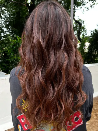 The back view of the 'Almond Brown' hair, styled with soft waves.