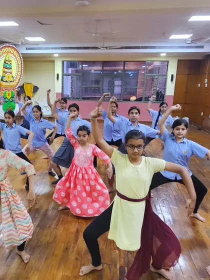 Students in a school workshop holding a strong, synchronized pose, fully engaged in their Chhau training.