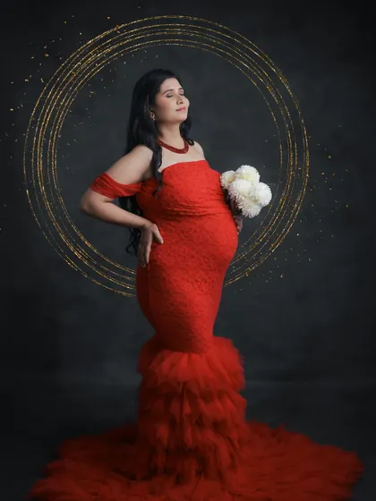 A powerful portrait in a striking red mermaid-style gown. The added sparkle effect and dark background make this a glamorous and memorable shot.