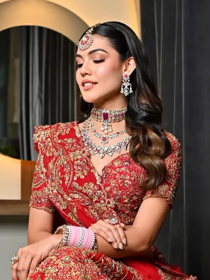 A portrait of the bride with her dreamy red bridal hairstyle. The soft waves and side part create a modern yet timeless look that is full of elegance.