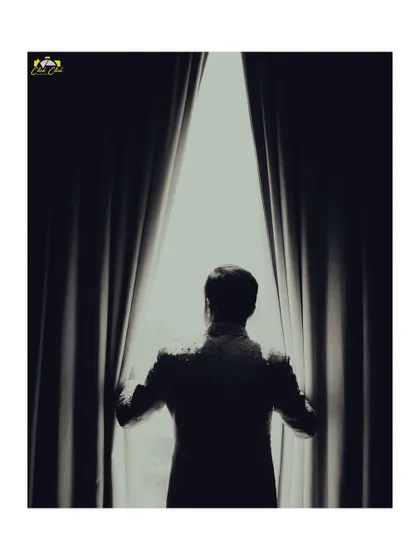 A silhouette of the groom looking out the window. This artistic, moody shot creates a sense of anticipation and contemplation before the big moment.