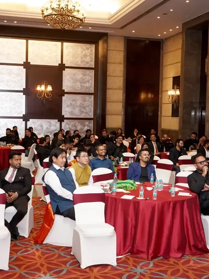 A wide shot of attendees at a corporate conference. I handle all logistics for large groups, including seating, catering, and breakout session management.