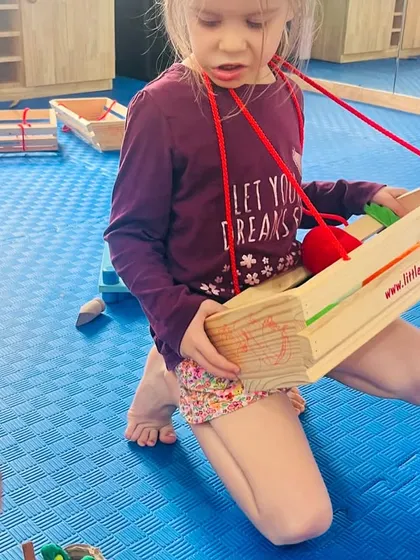 A child uses a toy scale, pretending to weigh items. Role-play zones are filled with tools and props that encourage exploration of different professions and life skills.