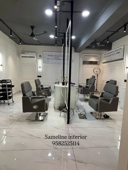 A look at the main cutting section of our East Patel Nagar salon project. We designed this space with custom-lit mirrors, clean marble-finish flooring, and elegant wall mouldings to create a high-end, professional atmosphere for clients.